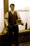 Joe in arches with top hat in hand