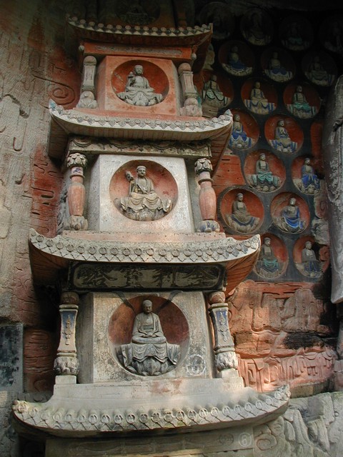 Facing pagoda near three standing saints