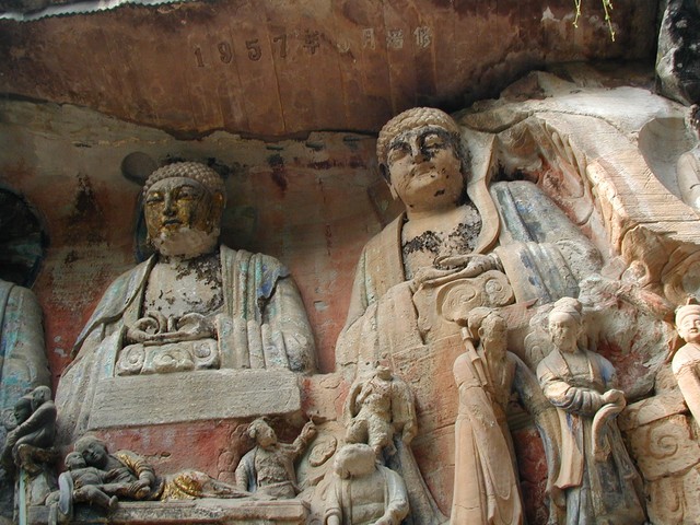 Focus on buddhas above mother in golden robe holding her child with 1957 inscription in the Great Kindness of Parents group