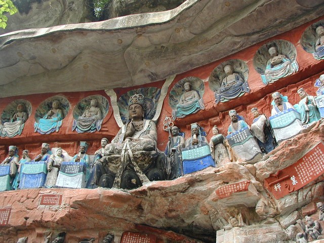 Larger view of a group of statues showing life in heaven and hell and on earth