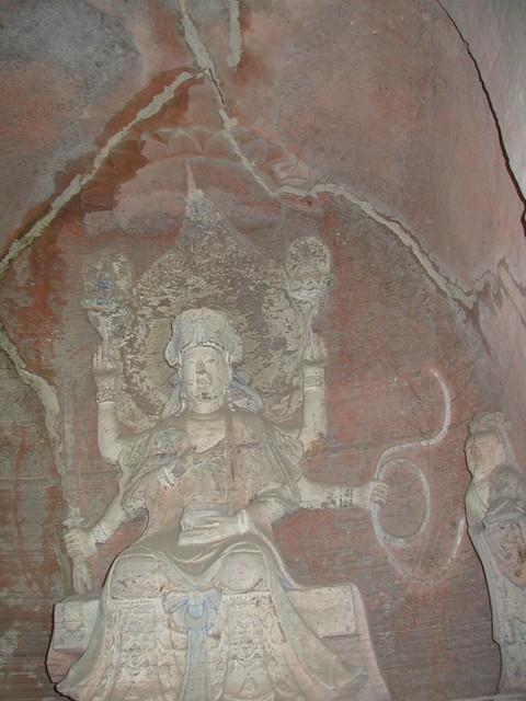 Top portion of buddha with ornate legs in lotus flower blossoms