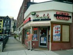 Tom below the Bunghole Liquors sign