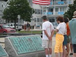 checking out the names on the plaque in Gloucester Harbor