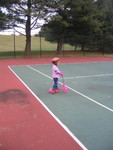 Tennis court is a safe spot for Ella scootering