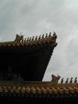 Tiled roof with double eaves and is decorated with carved dragons and phoenixes