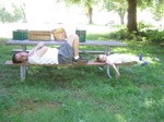 John and Ella lounging on the picnic bench