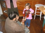 Ella picks-up the violin