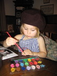 Ella in her artist hat painting a picture