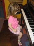 Ella ponders the piano