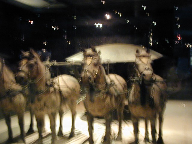 Bronze chariot visible behind the horses