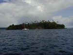 Tiny catamaran in front of Island