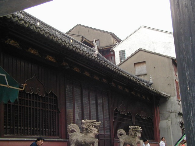 Concrete housing is built up against the side of Yuyuan Garden