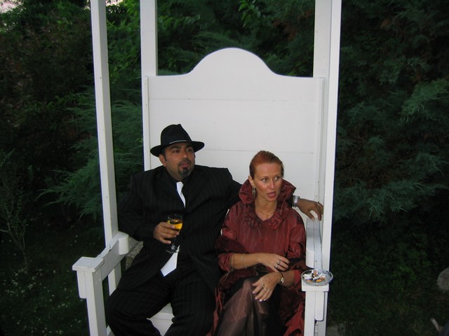 Ajay and Sharon in the big white chair out back